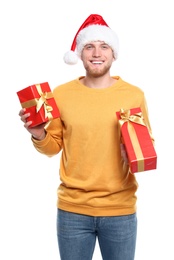 Young man with Christmas gifts on white background