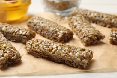 Photo of Delicious sweet kozinaki bars on parchment paper, closeup