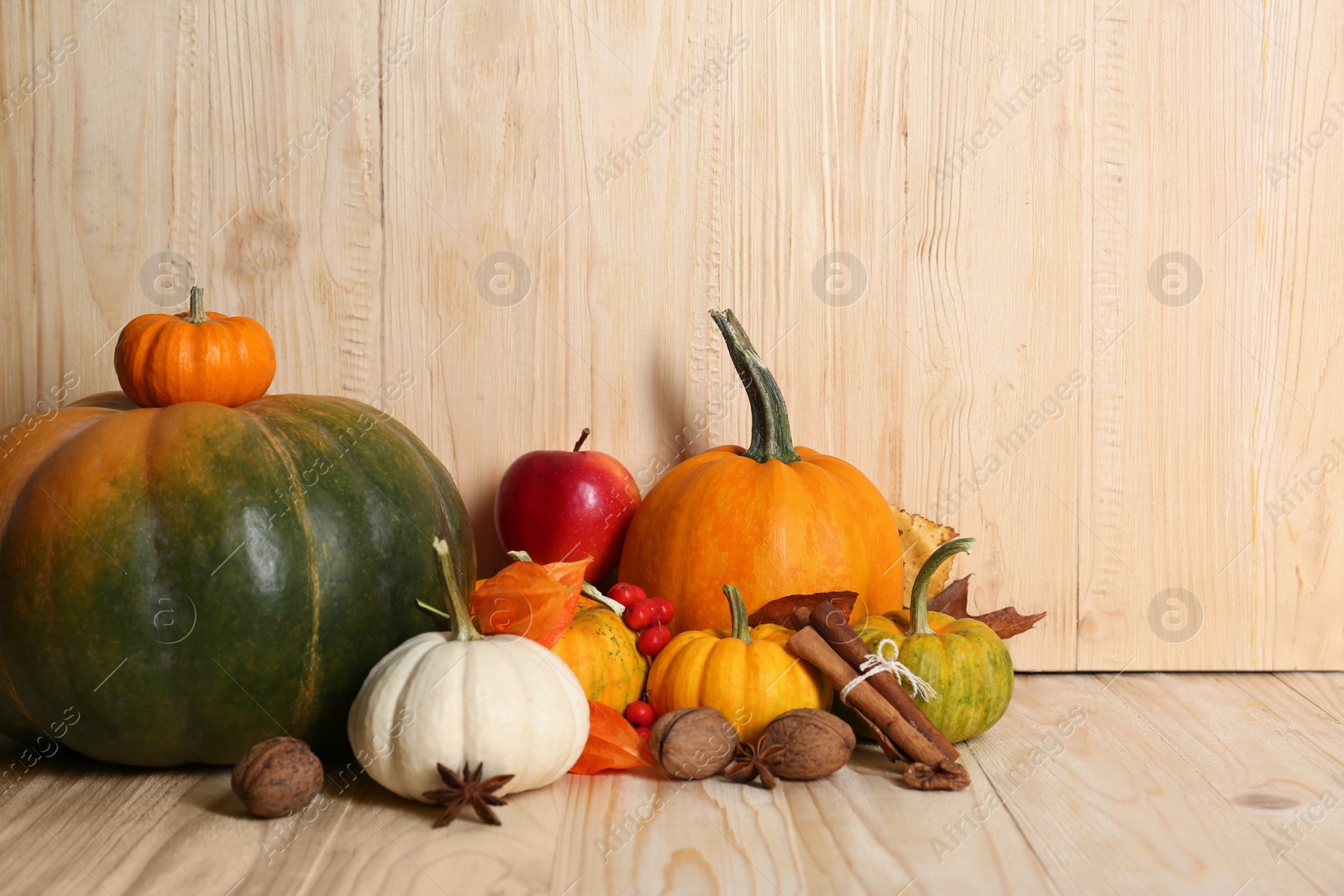 Photo of Happy Thanksgiving day. Beautiful composition with pumpkins on wooden table, space for text