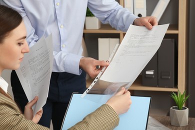 Businesspeople working with documents in office, closeup