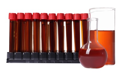 Different laboratory glassware with brown liquids on white background