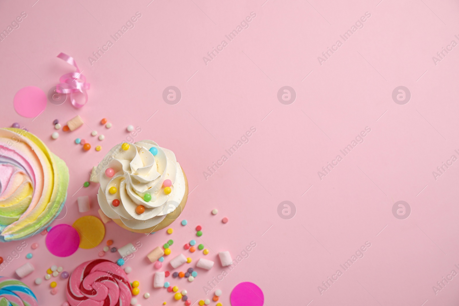 Photo of Flat lay composition with cupcake on pink background, space for text. Birthday party
