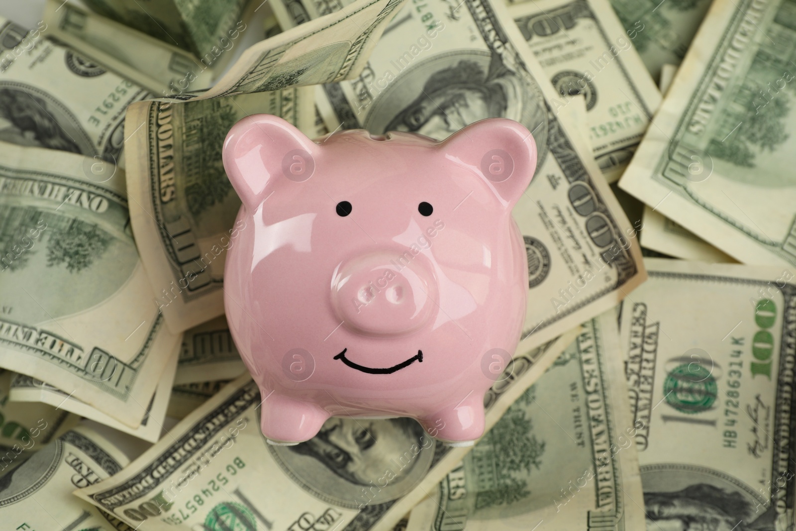 Photo of Money exchange. Dollar banknotes and piggy bank, closeup