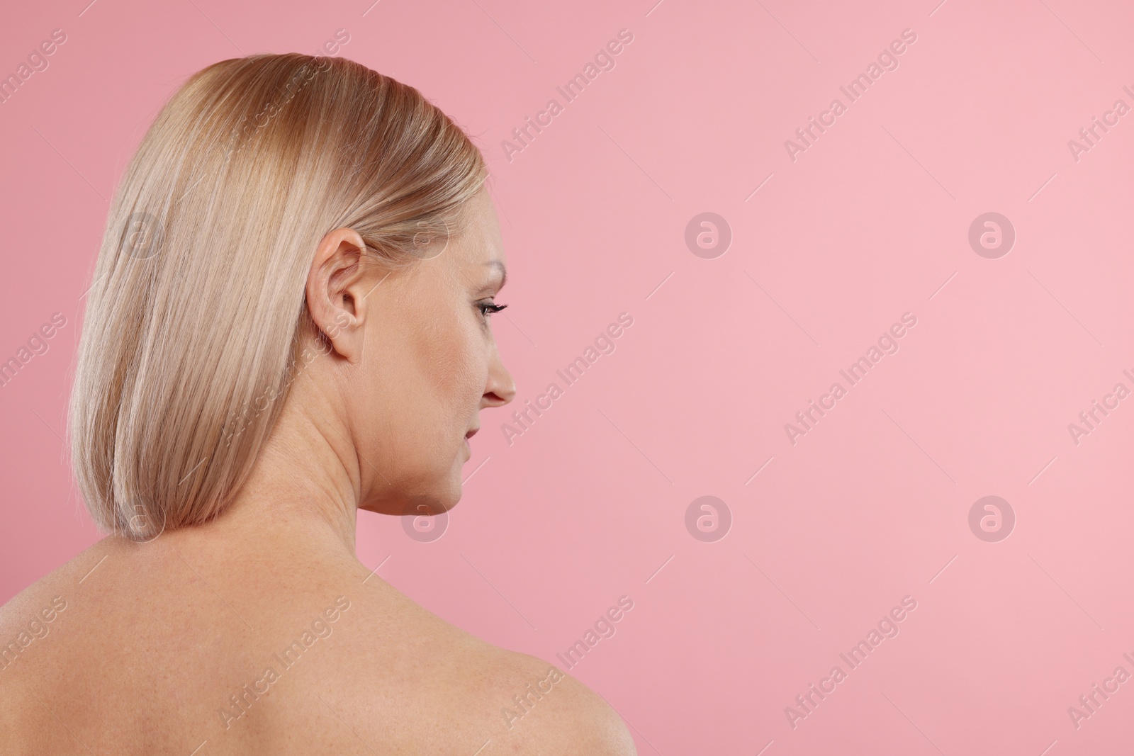 Photo of Beautiful woman with healthy skin on pink background. Space for text