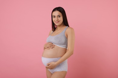 Photo of Beautiful pregnant woman in comfortable maternity underwear on pink background