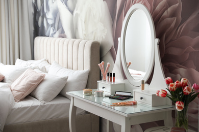 Photo of Stylish bedroom interior with elegant dressing table and floral wallpaper