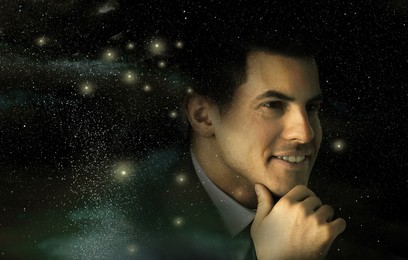 Double exposure of handsome man and starry sky. Astrology concept