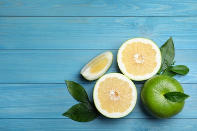 Photo of Fresh ripe sweeties on blue wooden table, flat lay. Space for text