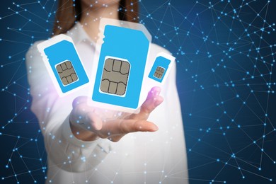 Image of Woman demonstrating SIM cards of different sizes on color background, closeup 
