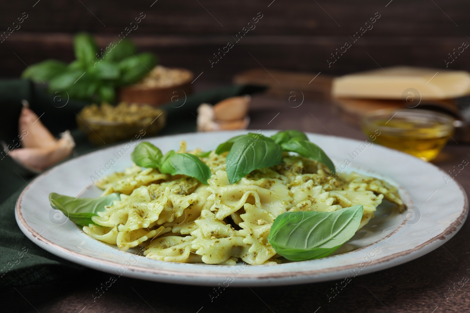 Photo of Delicious pasta with pesto sauce and basil on table, closeup. Space for text