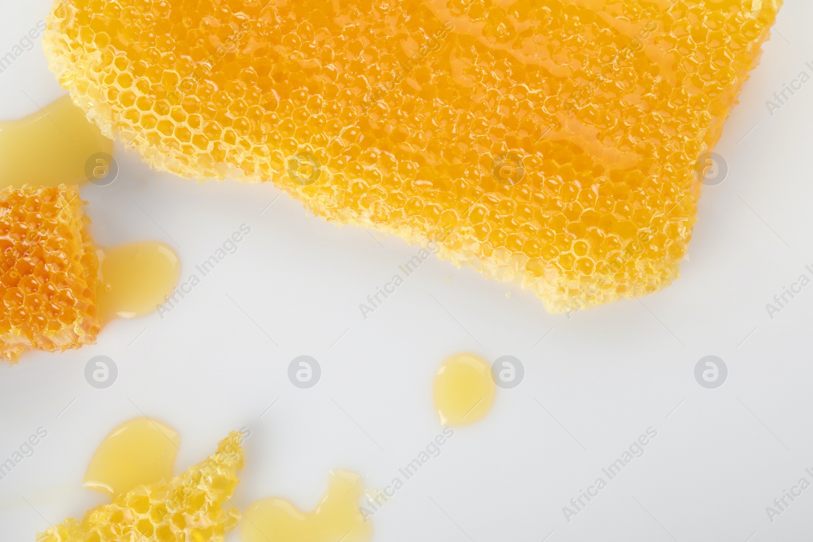 Photo of Natural honeycombs with tasty honey on white background, flat lay