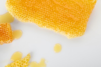 Natural honeycombs with tasty honey on white background, flat lay