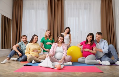 Photo of Group of pregnant women and men at courses for expectant parents