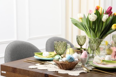 Festive table setting with beautiful flowers, space for text. Easter celebration