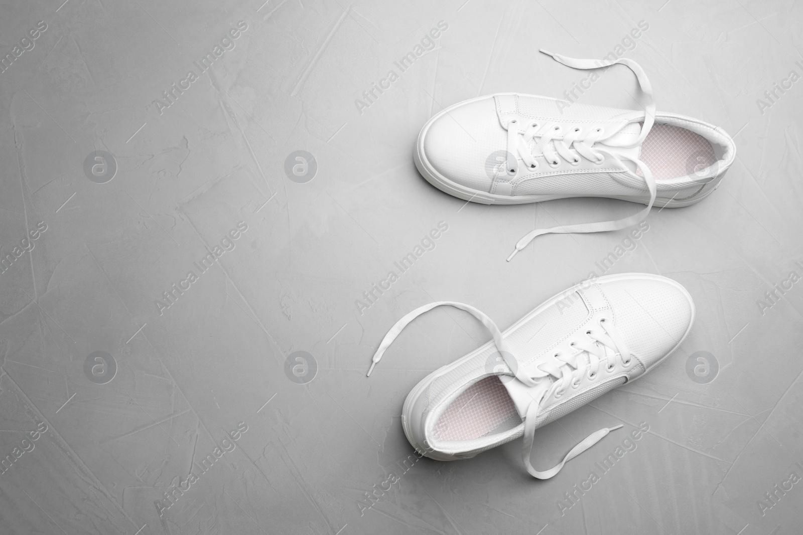 Photo of Pair of stylish shoes on grey background, top view. Space for text