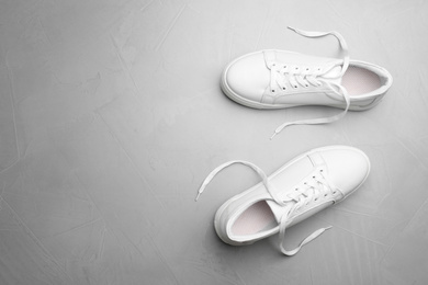 Pair of stylish shoes on grey background, top view. Space for text