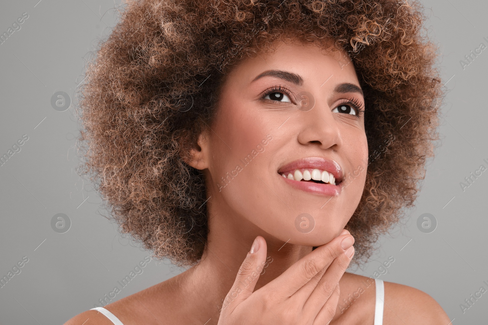 Photo of Beautiful woman with healthy skin on gray background