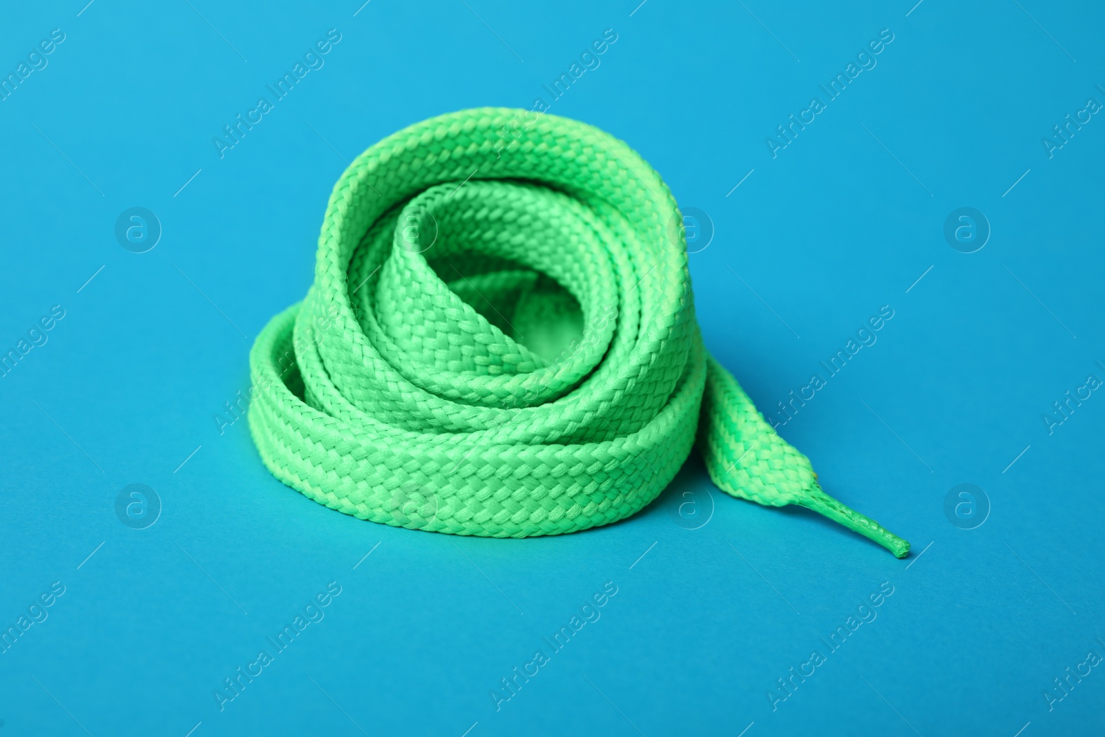 Photo of Mint shoe lace on light blue background