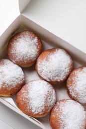 Delicious sweet buns in box on table, top view