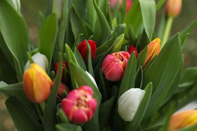 Photo of Beautiful bouquet of colorful tulips outdoors, closeup