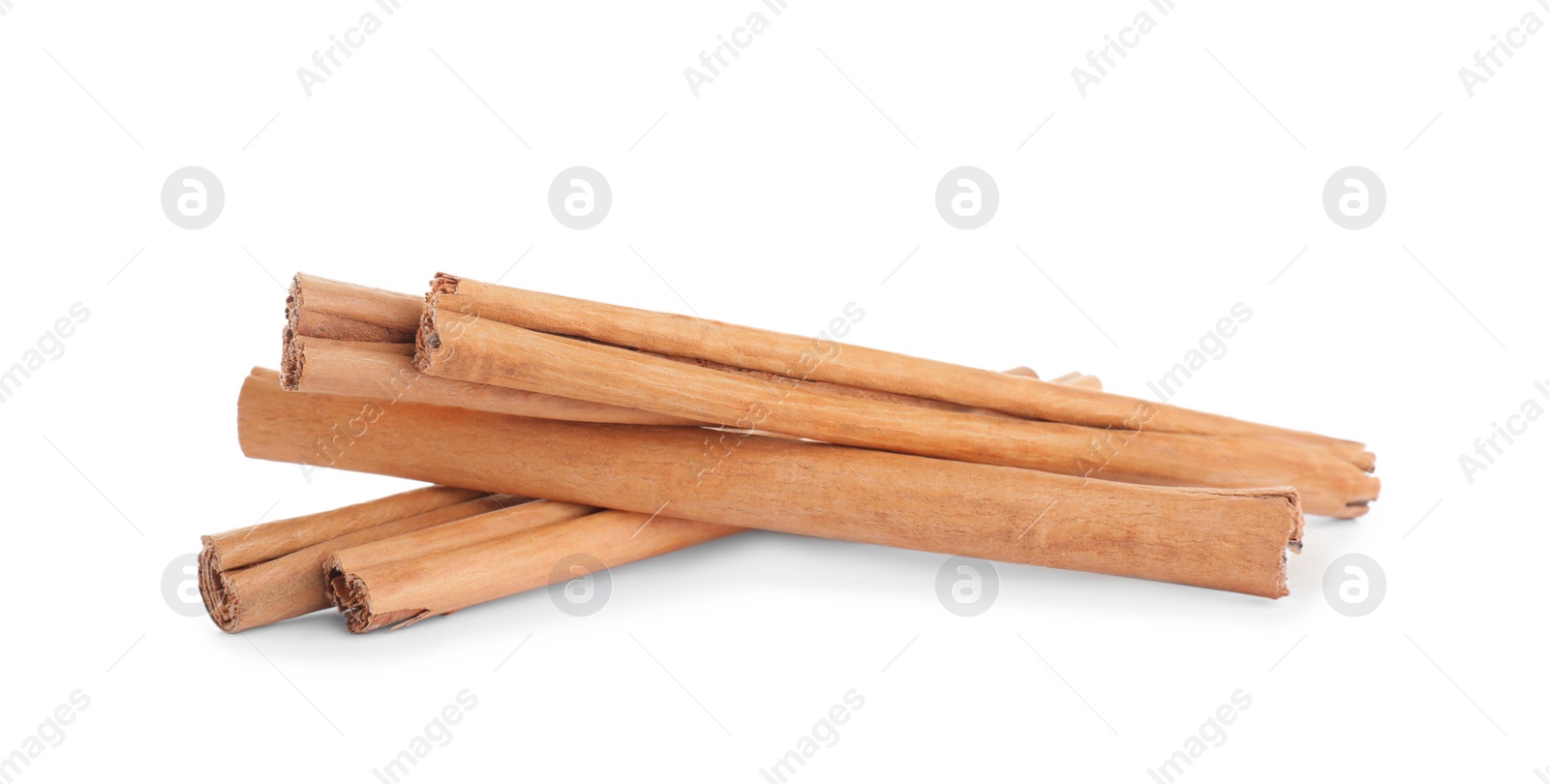 Photo of Aromatic brown cinnamon sticks on white background