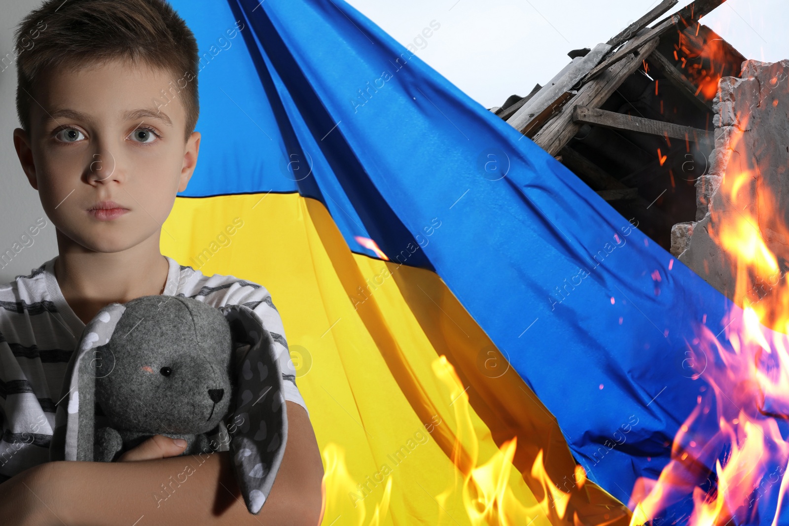 Image of Sad little boy with toy, national flag and ruined house on fire. Stop war in Ukraine