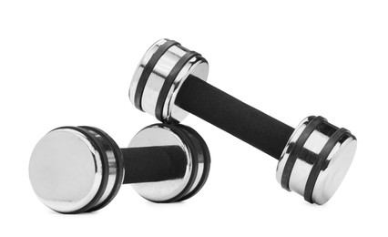 Photo of Metal dumbbells isolated on white. Sports equipment