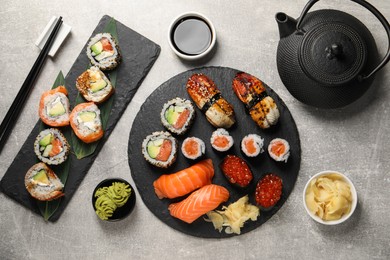 Photo of Flat lay composition with delicious sushi rolls on light grey table
