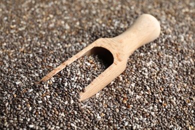 Photo of Wooden scoop and chia seeds, closeup. Organic superfood