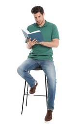 Handsome man reading book on white background