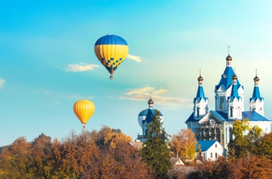 Photo of KAMIANETS-PODILSKYI, UKRAINE - OCTOBER 06, 2018: Beautiful view of hot air balloons flying near Saint George's Cathedral