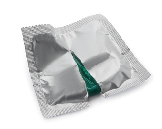 Torn package with condom isolated on white. Safe sex