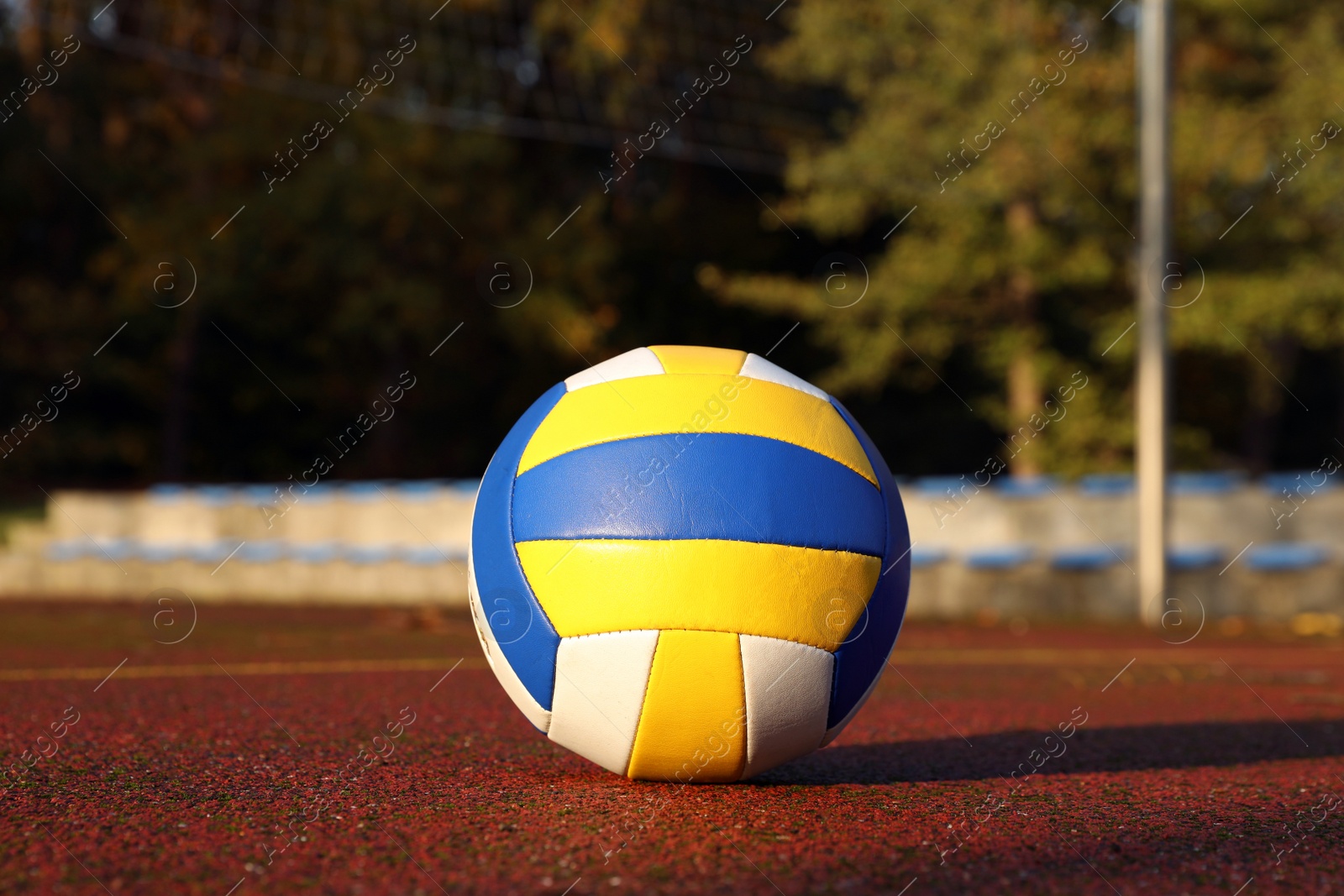 Photo of View of colorful ball on volleyball court outdoors