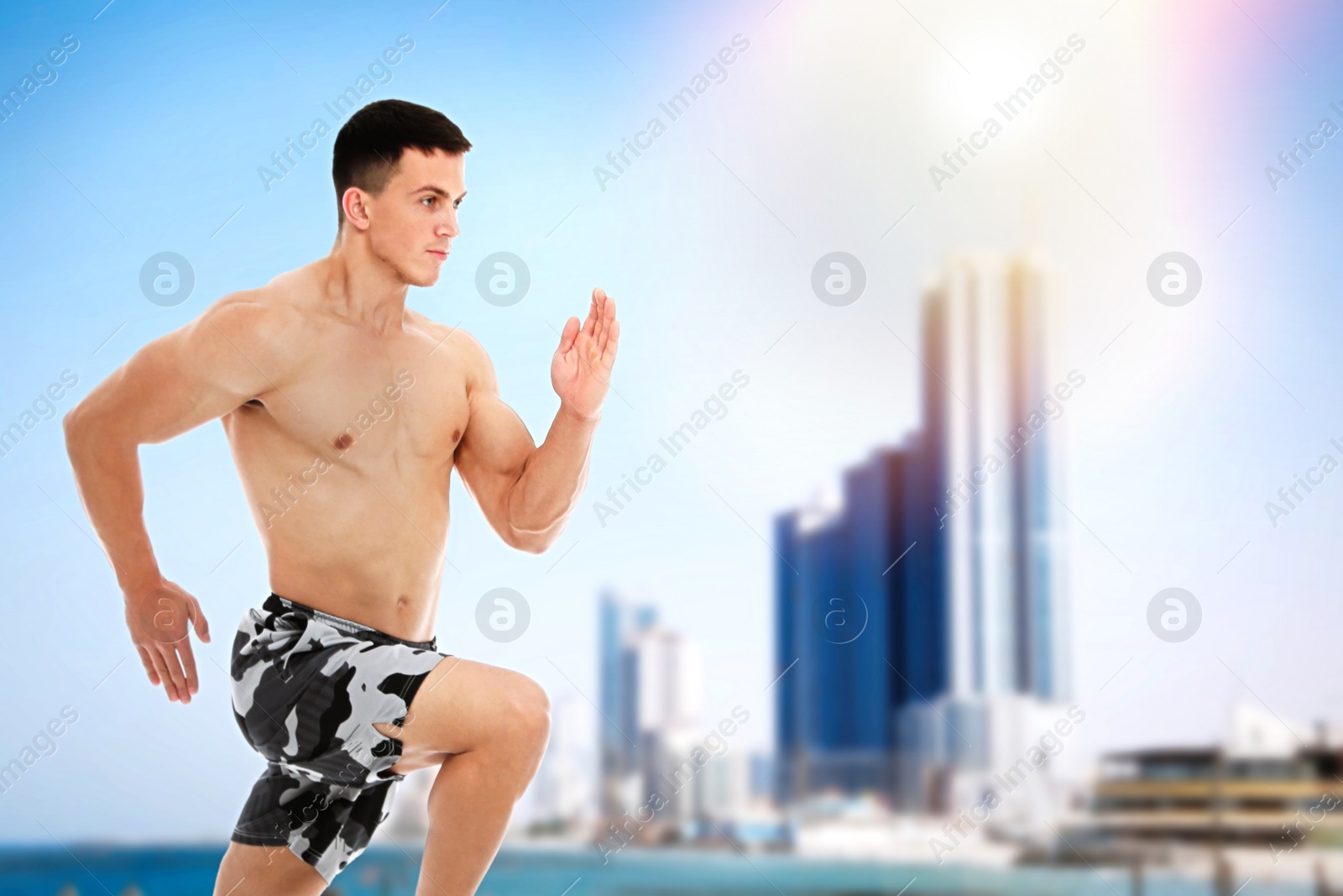 Image of Athletic young man running near sea on sunny day, space for text 