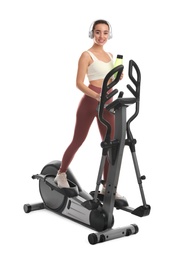 Photo of Woman with bottle using modern elliptical machine on white background