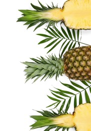 Photo of Whole and cut ripe pineapples on white background, flat lay. Space for text