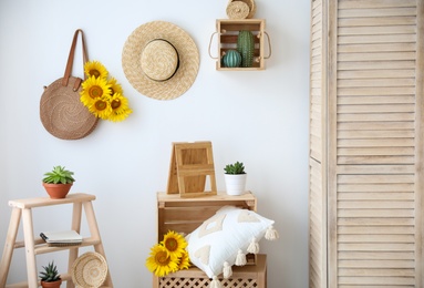 Bag with bouquet of beautiful sunflowers in stylish room interior