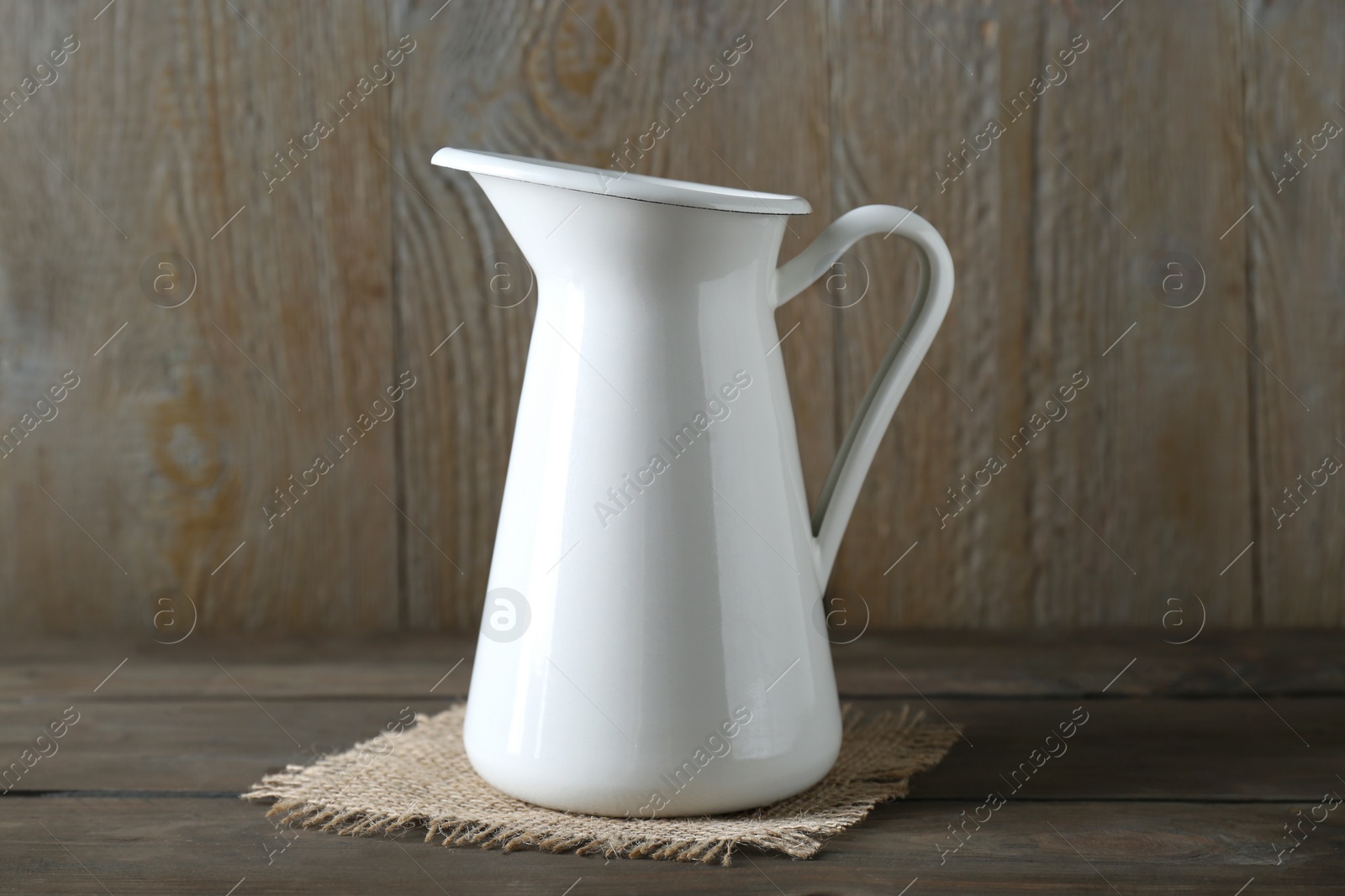 Photo of One beautiful white jug on wooden table