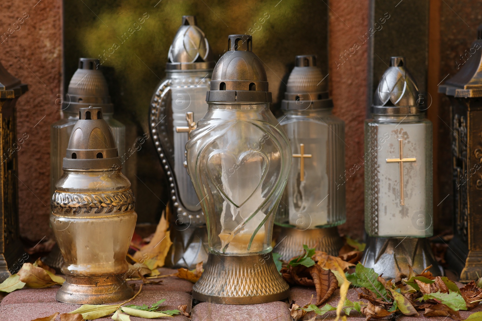 Photo of Grave lanterns on stone surface in cemetery