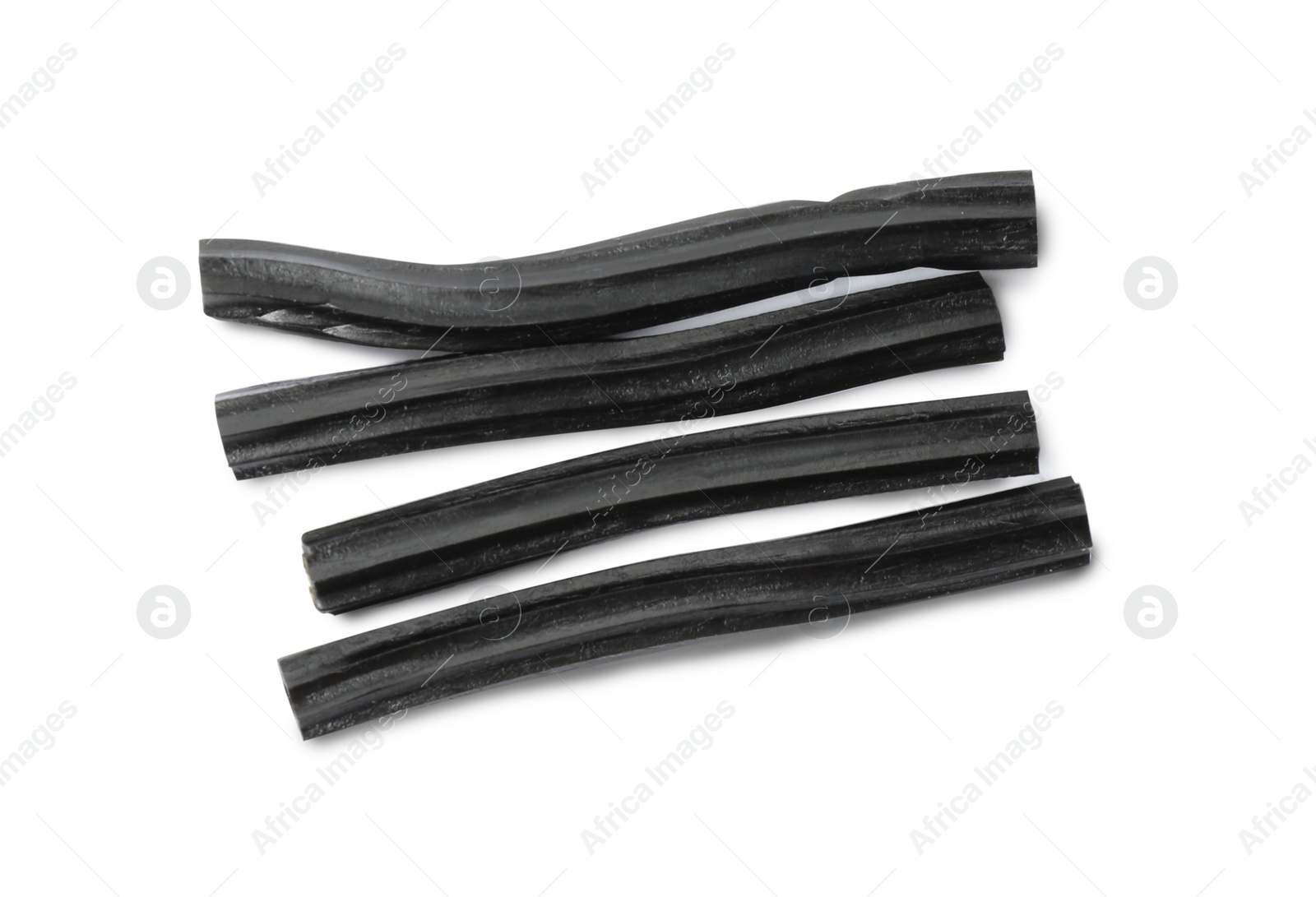 Photo of Tasty black liquorice candies on white background, top view