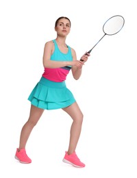 Young woman playing badminton with racket on white background