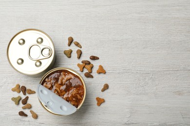 Wet and dry pet food on white wooden table, flat lay. Space for text