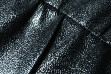 Photo of Black leather with seam as background, top view