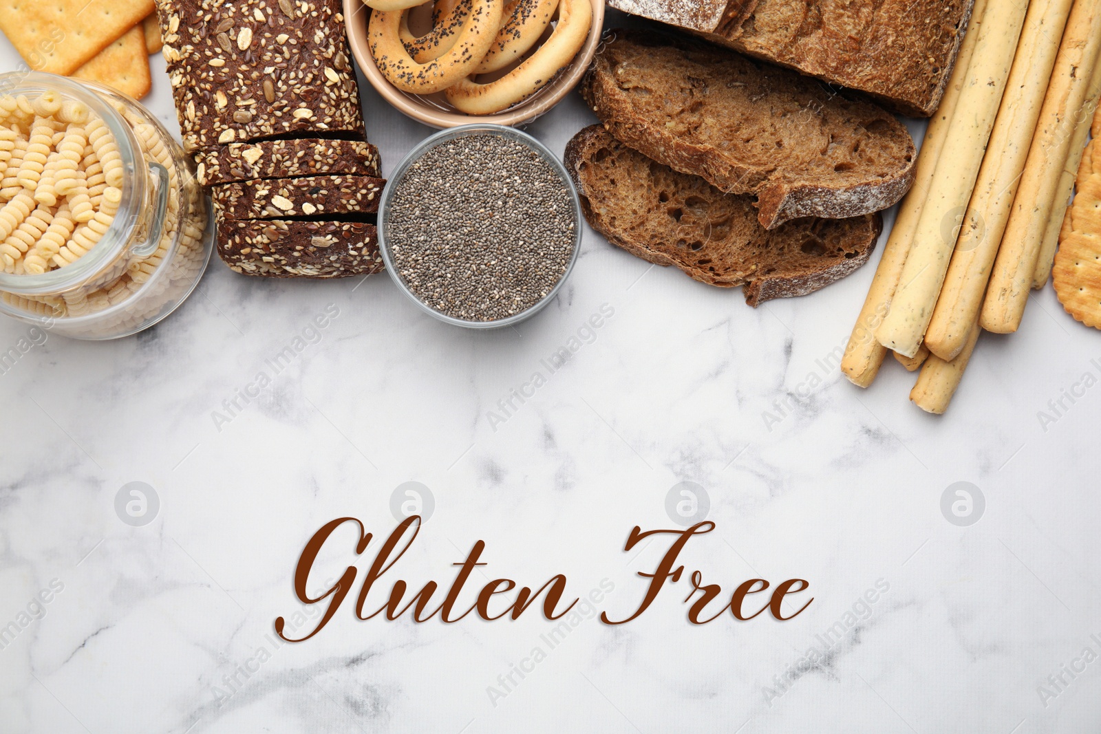 Image of Different gluten free products on white marble table, flat lay