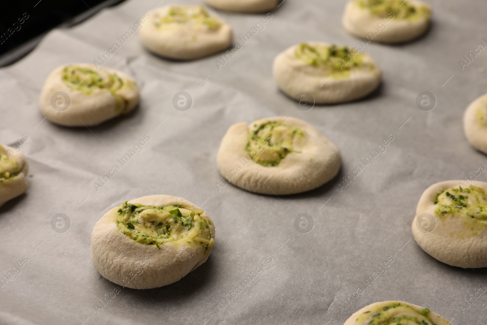 Photo of Raw puff pastry with tasty filling, closeup