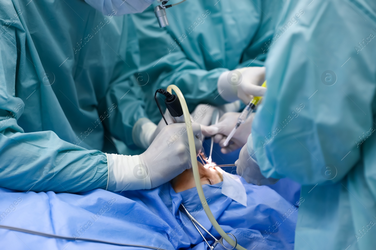 Photo of Professional doctors performing 
frontal sinus trephination in surgery room, closeup