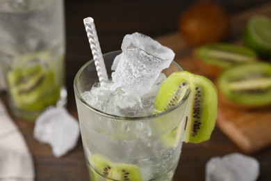 Photo of Glass of refreshing drink with kiwi on table, closeup