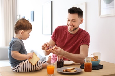 Dad and his son having breakfast in kitchen