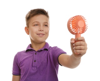 Little boy enjoying air flow from portable fan on white background. Summer heat