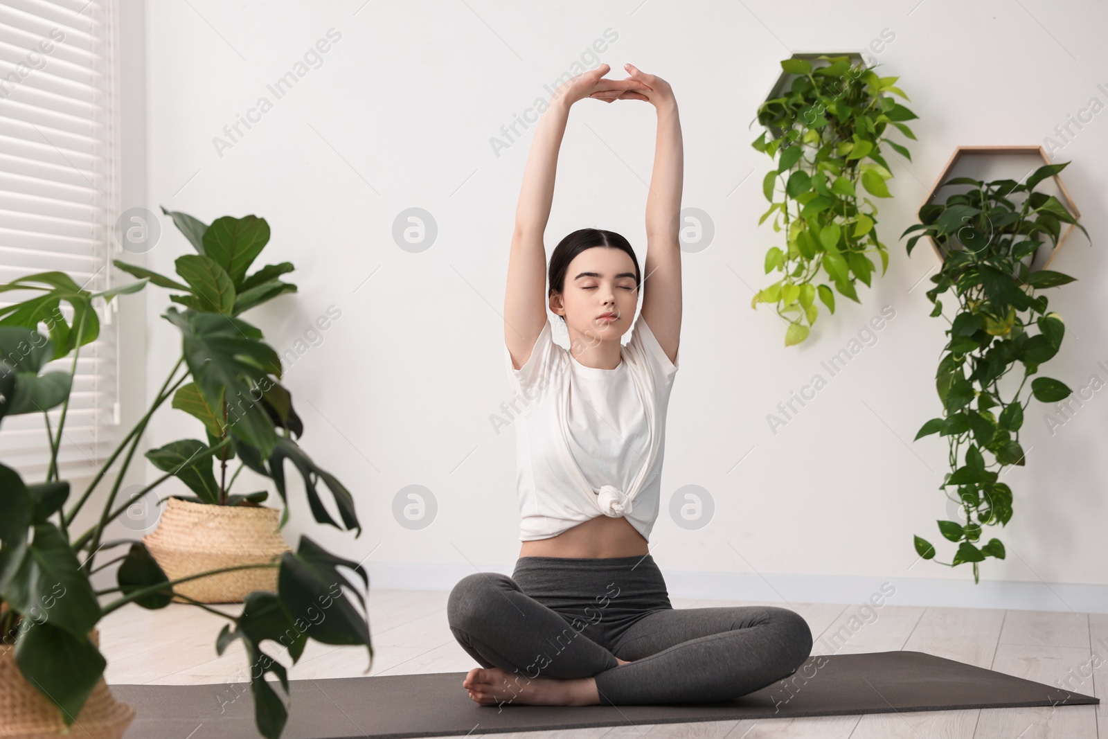 Photo of Beautiful girl meditating on mat in yoga studio